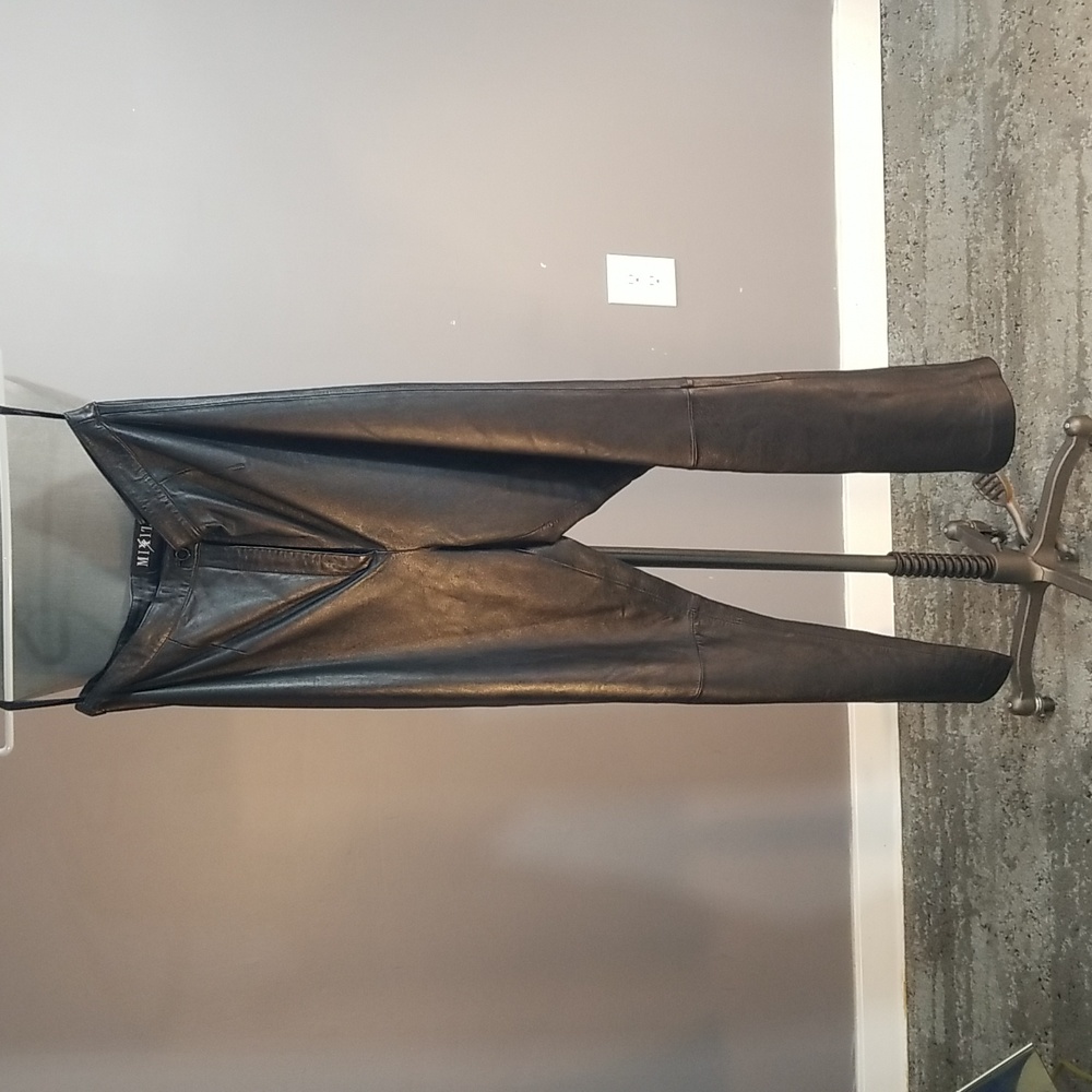 Black genuine leather womens pants size 14 flat front.  Partially lined.  Sharp